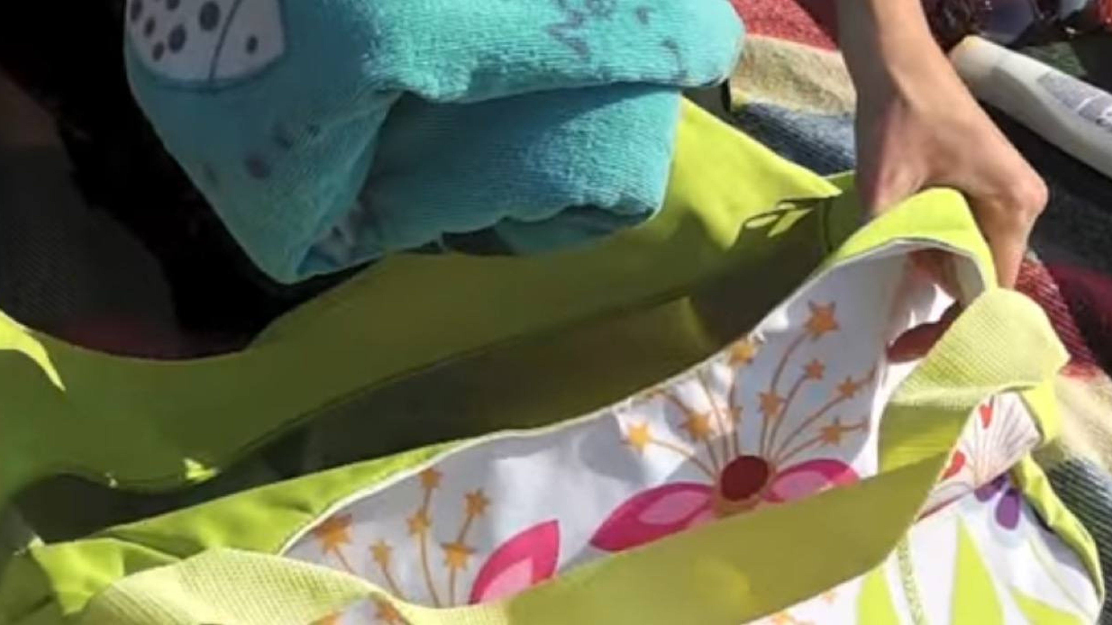 Putting a towel in the beach bag