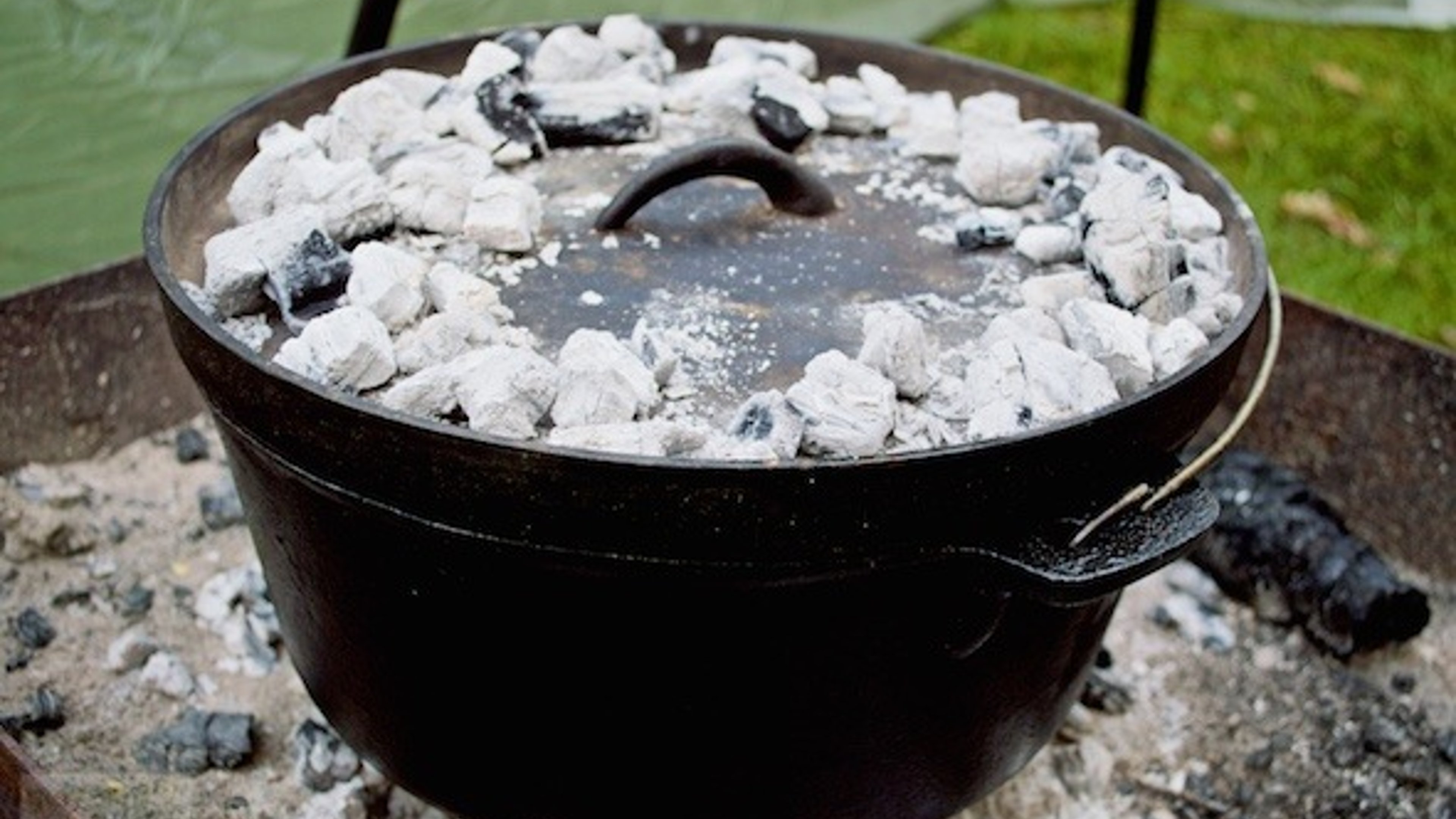 Coals on top of the Dutch Oven in the campfire