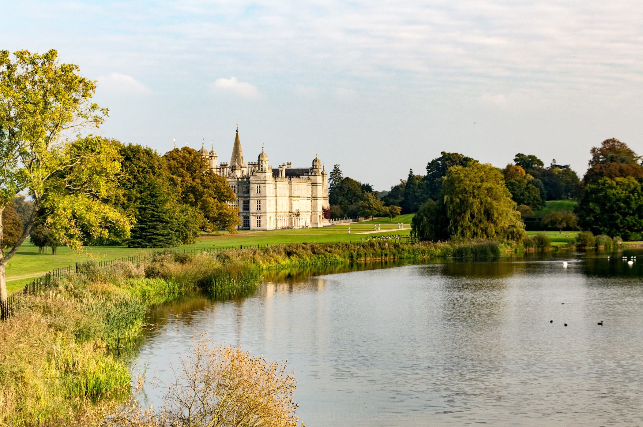 Burghley House next to the lake