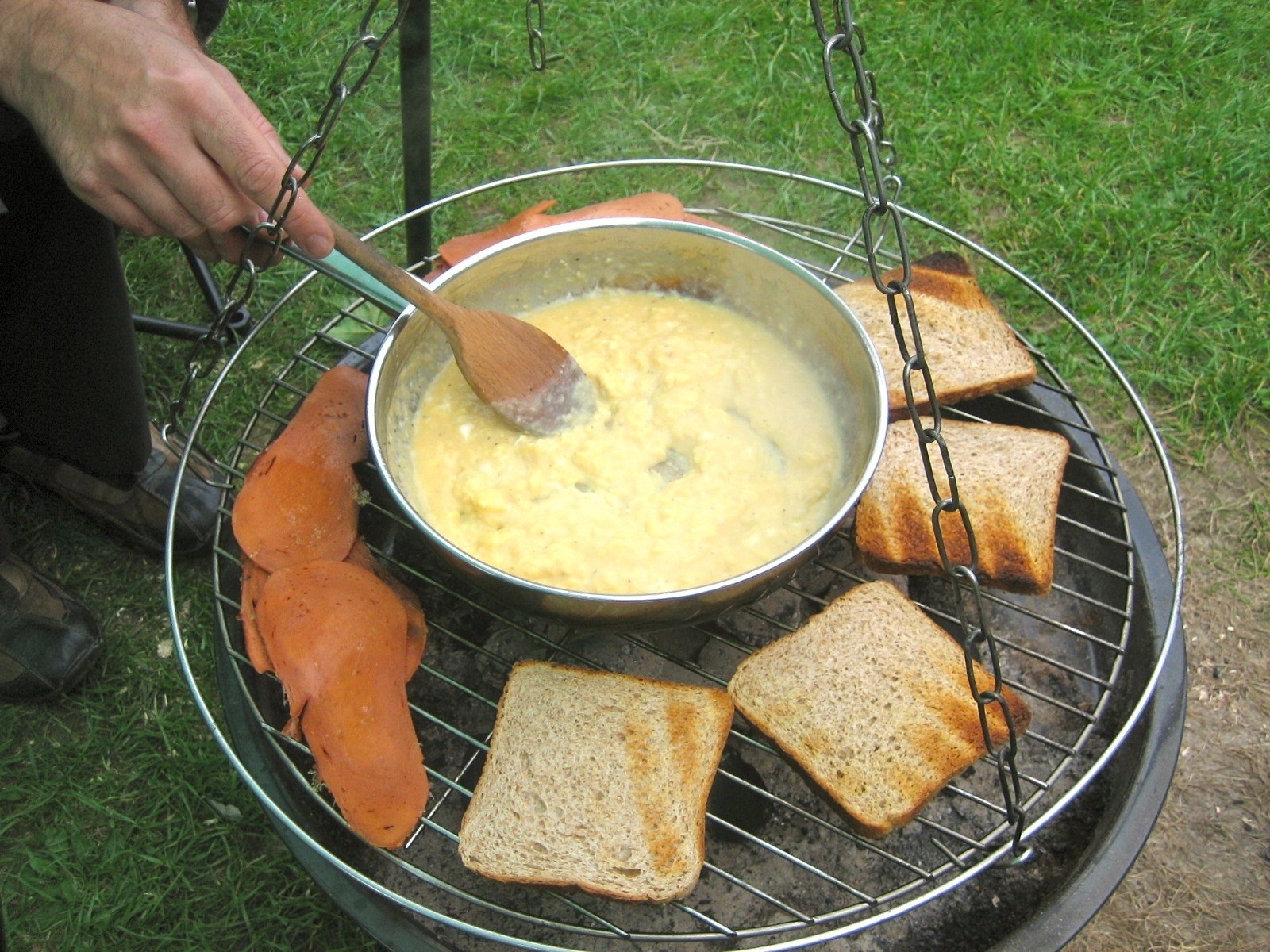 Breakfast cooking on the tripod grill