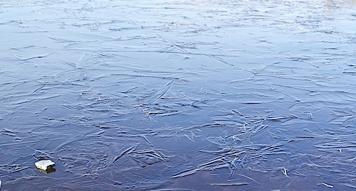 Stone on frozen pond