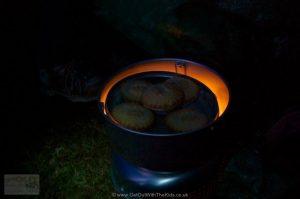 Trangia warming mince pies at night on a very cold hill