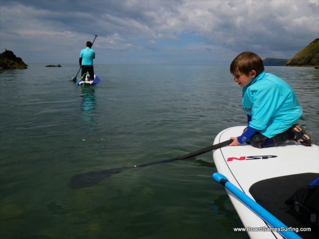 Small kids can sit on the front of an adult's SUP board