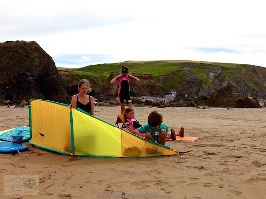 Filling the pockets on the Easy Camp Surf with sand to weight it down