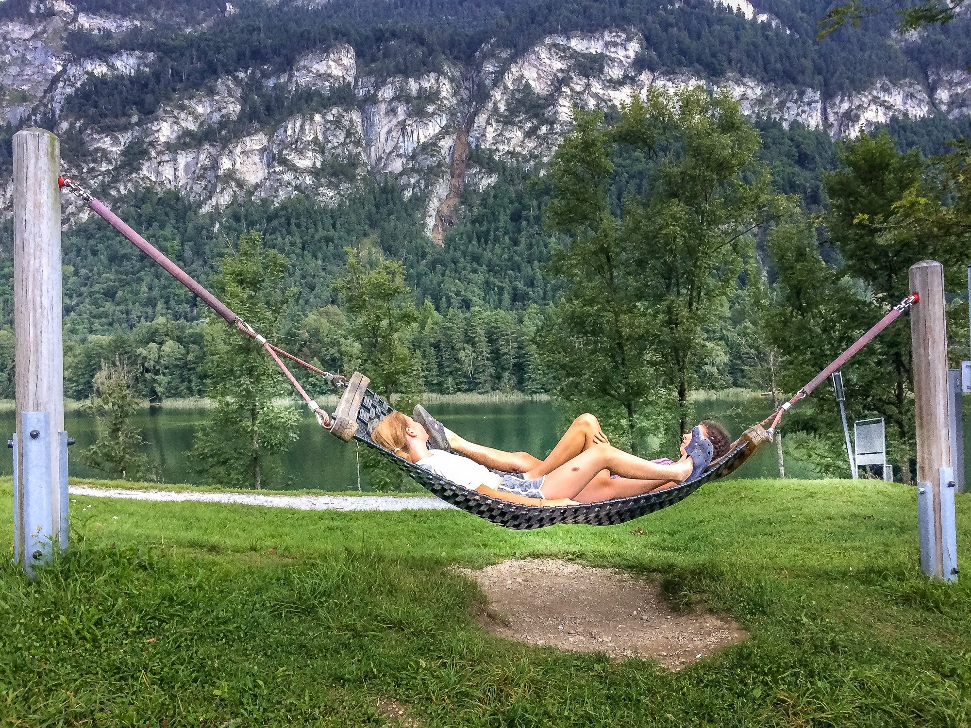 A hammock by the lake with view of the mountains