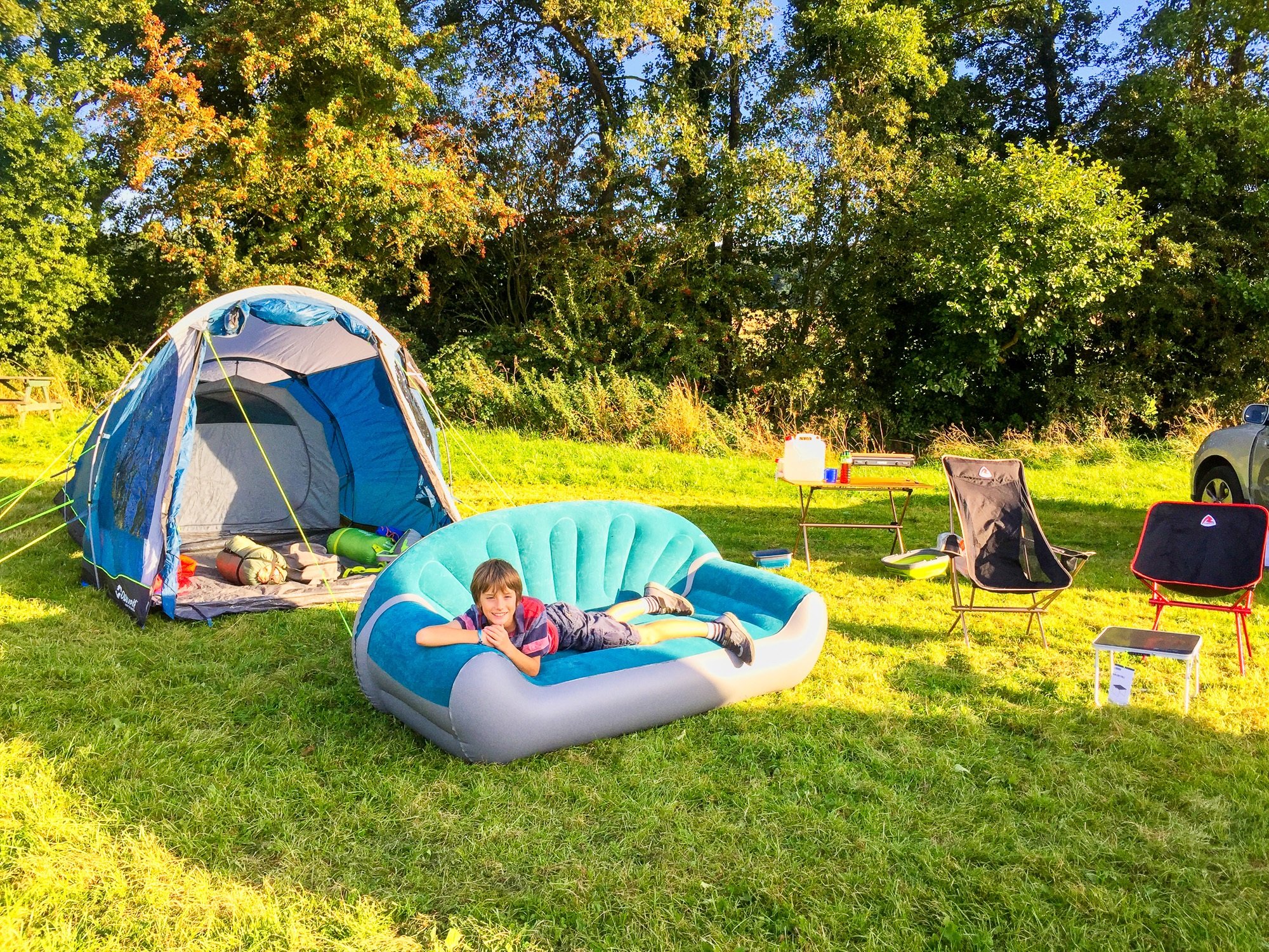 Outwell Vigor tent and sofa at campsite