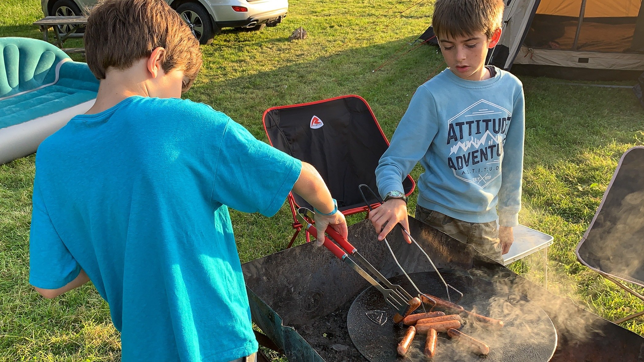 Kids cooking over the campfire