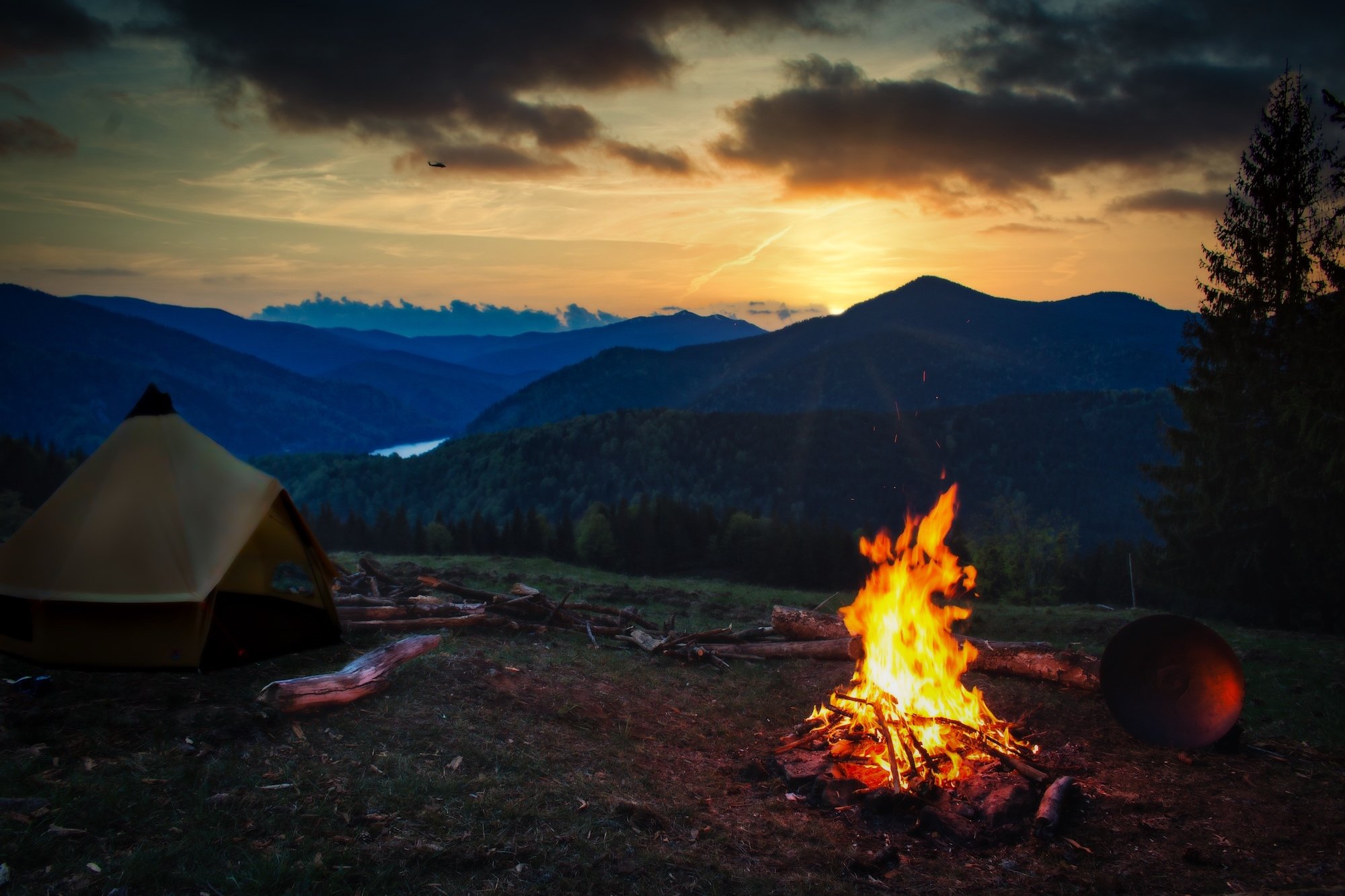 Robens Klondike Grande Tipi tent by a campfire