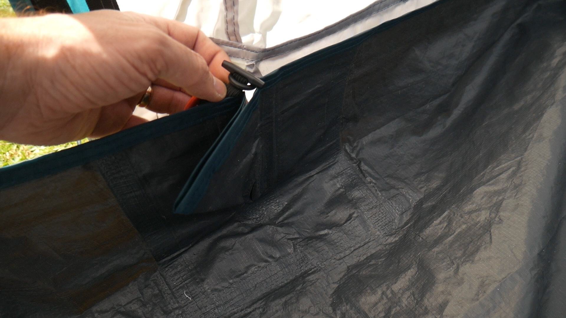 Toggling the groundsheet at the tent door