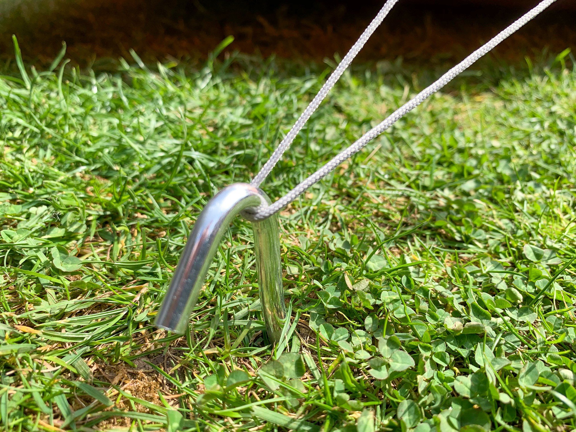 Alloy tent peg in the ground