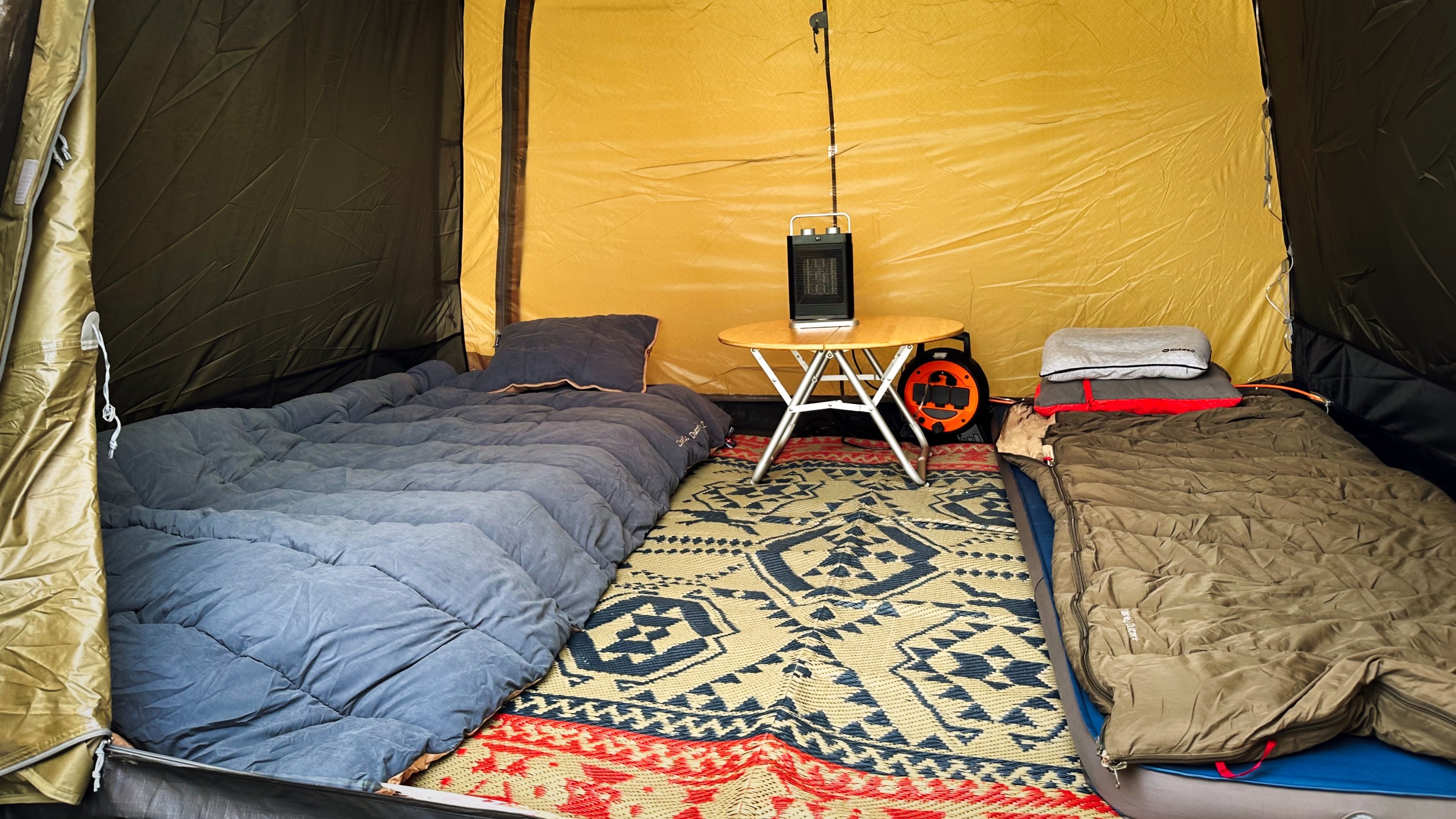 Inside the tent with sleeping bags and carpet set-up