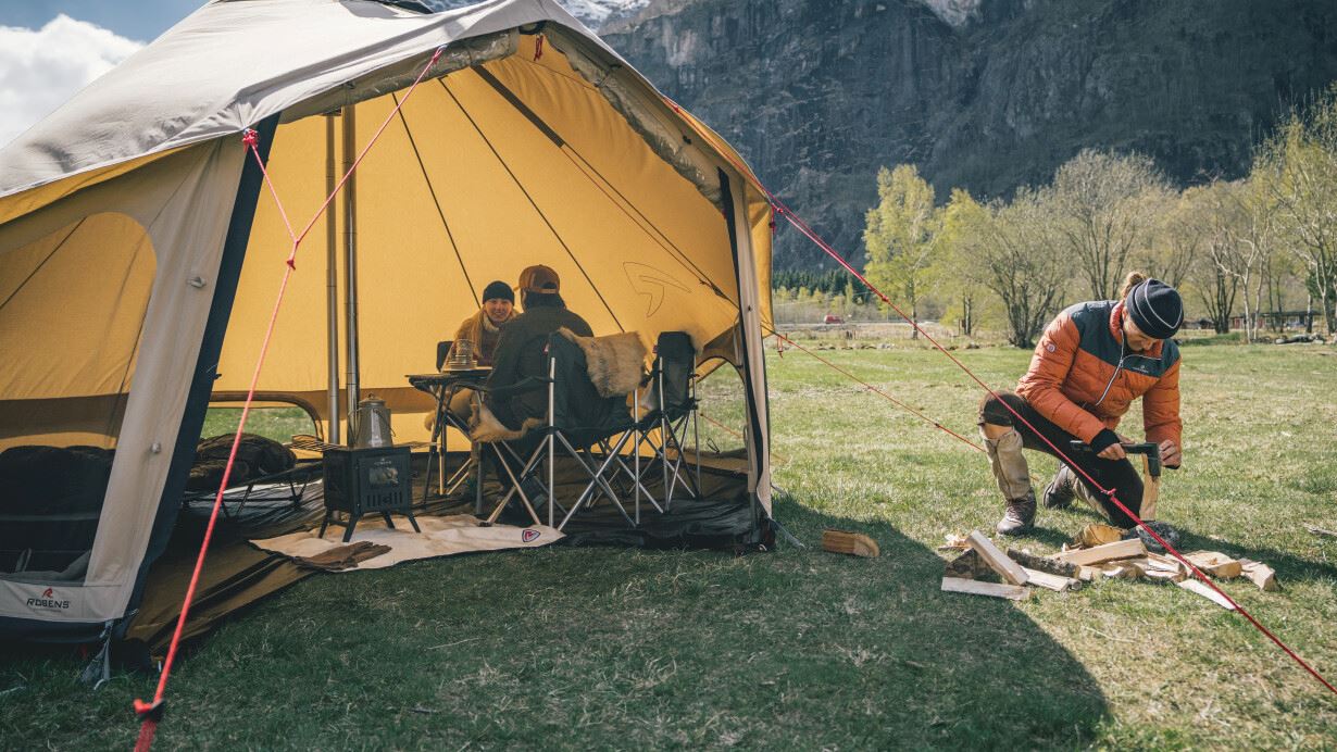People sitting inside the tent with the door open
